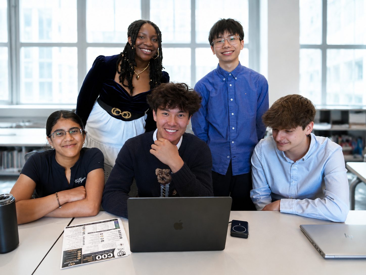 The five founding Student Civic Leaders gathered around a laptop